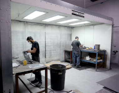 Workers in Dust Collection Booth Grinding and Sanding