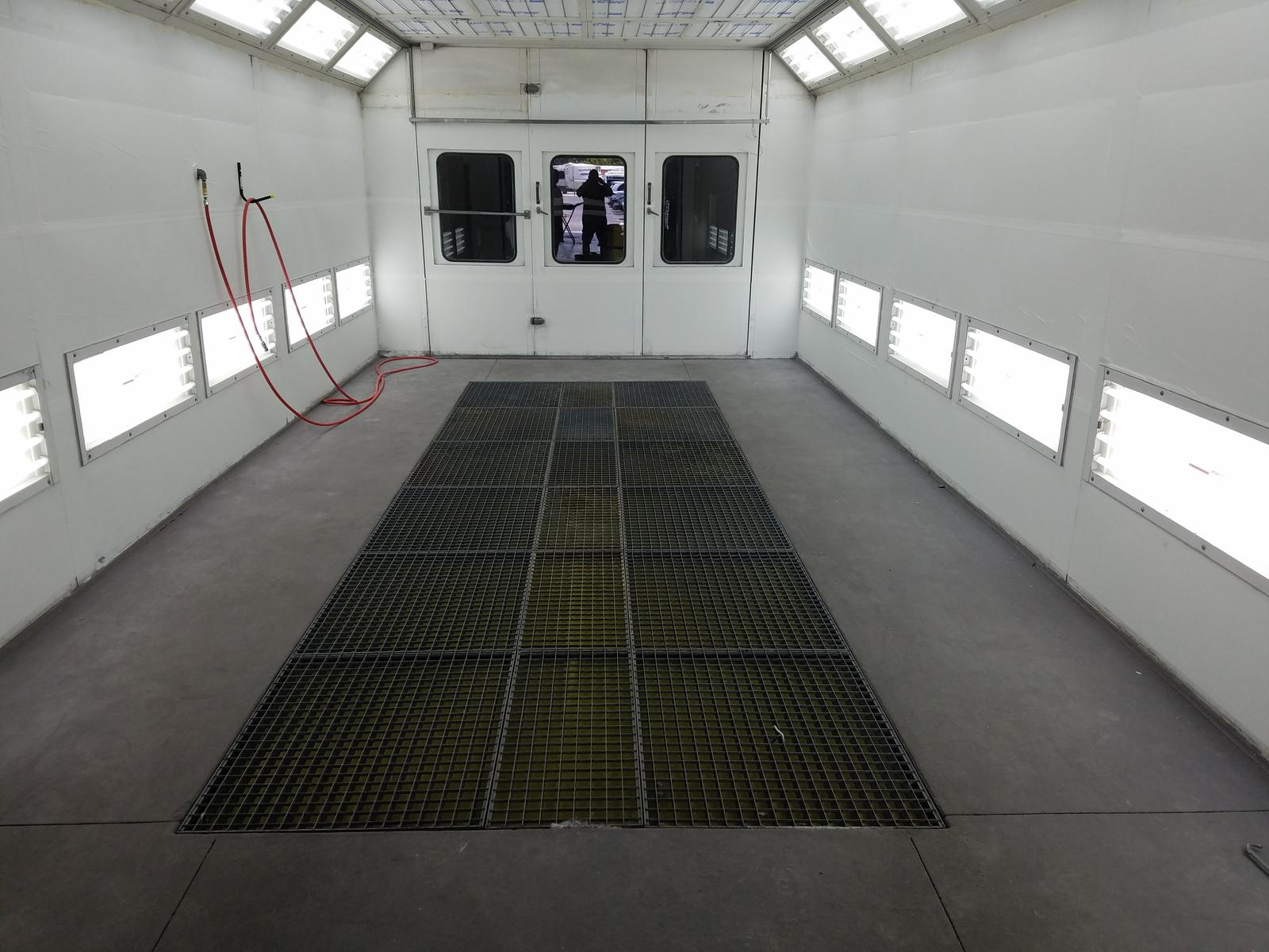 Home v4 2 Newly installed downdraft paint booth with lit wall panels and a grated floor pit